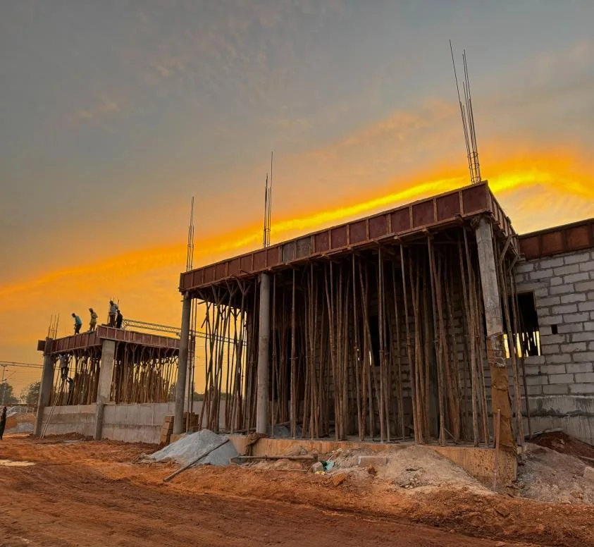 Slab work in progress at sunset on a Vijayalakshmi Buildtech site